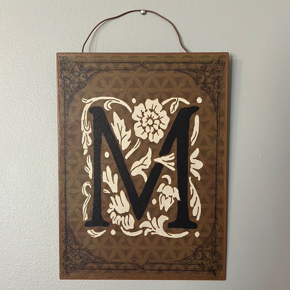 Vintage style sign with letter “M”